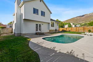 Rear view of house with a fenced backyard, french doors, a gate, and a patio area