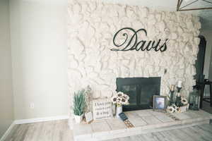 Unfurnished living room featuring a fireplace and wood finished floors