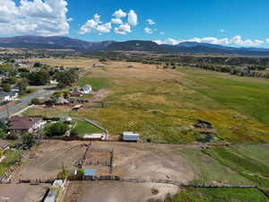 Aerial overview of property's location with rural landscape and a mountainous background