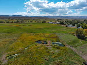 View of rural area with a mountainous background and agricultural land