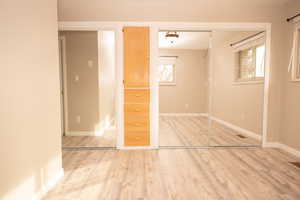 Unfurnished bedroom featuring a closet and light wood finished floors