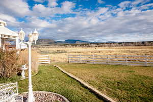 View of yard with a mountain view and a rural view