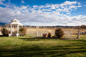 View of yard featuring a rural view, a gazebo, and a mountain view