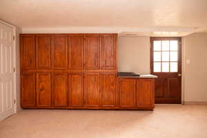 Interior space with carpet floors and a textured ceiling