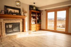 Unfurnished living room featuring wood finished floors and a fireplace