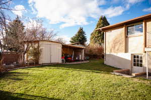 View of yard featuring an outdoor structure and a patio area