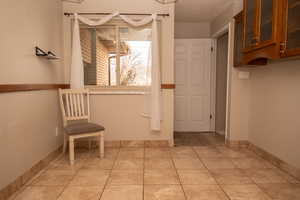 Hallway featuring light tile patterned floors