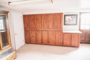 Unfurnished bedroom with multiple windows and light colored carpet