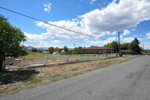 View of asphalt street featuring a rural view