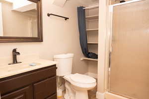 Bathroom featuring vanity, a shower stall, and light tile patterned floors
