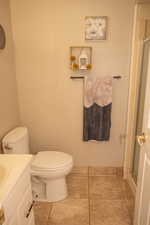 Bathroom with a shower stall and vanity