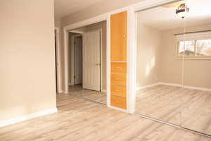 Unfurnished room with light wood-style flooring and baseboards