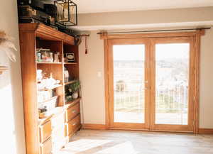 Doorway featuring wood finished floors and french doors
