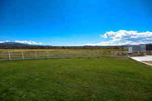 View of yard featuring a view of countryside and a mountain view