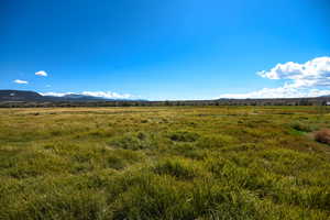View of mountain backdrop with rural landscape