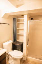Full bathroom with a shower stall, vanity, and light tile patterned floors