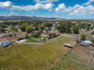 Aerial view of sparsely populated area with a mountainous background and a pastoral area