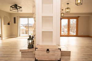 Detailed view of built in shelves, wood finished floors, and a textured ceiling