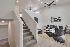 Living room with recessed lighting, stairway, ceiling fan, and light wood finished floors