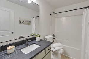 Full bath featuring vanity and shower / tub combo with curtain