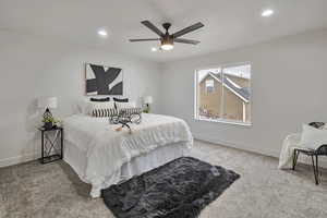 Bedroom featuring light colored carpet, a ceiling fan, and recessed lighting