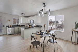 Dining room featuring a chandelier, light wood-style floors, and plenty of natural light