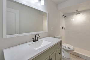 Bathroom featuring vanity and a shower stall