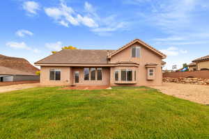 Rear view of property featuring stucco siding and a patio area