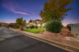 Obstructed view of property featuring stucco siding and a front lawn