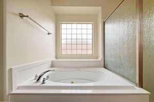 Full bath featuring a tub with jets