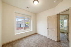 Spare room with carpet and a smoke detector