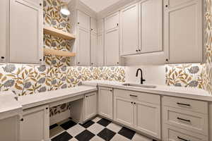 Washroom featuring dark floors and a sink