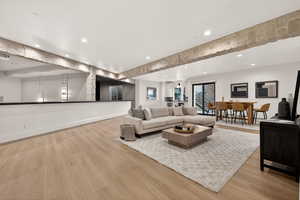 Living area featuring light wood finished floors and recessed lighting