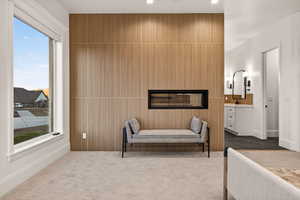 Bedroom with dark carpet, an accent wall, connected bathroom, and recessed lighting