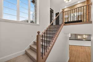 Staircase with baseboards and wood finished floors
