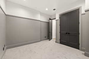 Unfurnished bedroom featuring carpet flooring, recessed lighting, and a closet