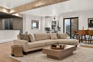 Living area with light wood-style floors, healthy amount of natural light, and recessed lighting