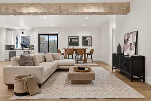Living area featuring light wood finished floors, wine cooler, and recessed lighting