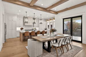 Dining room featuring light wood finished floors, recessed lighting, and beam ceiling