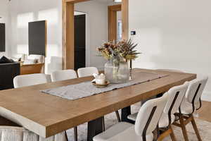 Dining room featuring light wood finished floors and baseboards