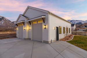 View of front of house with a mountain view, a garage, and driveway