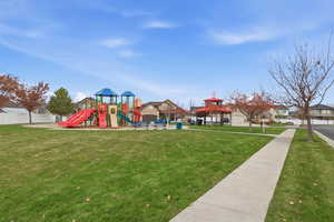 Community playground with a lawn, a gazebo, and a residential view