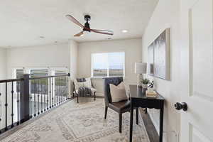 Office featuring a ceiling fan and light carpet