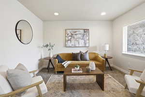 Carpeted living room with recessed lighting