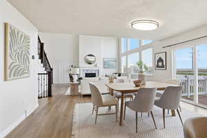 Dining space featuring a fireplace and light wood-style floors