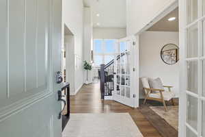 Entryway featuring dark wood-style floors, recessed lighting, and a high ceiling