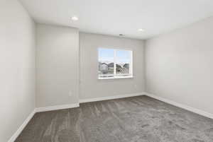 Empty room featuring carpet and recessed lighting