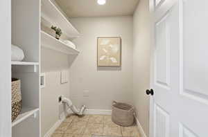 Laundry area with washer hookup, light tile patterned floors, hookup for an electric dryer, and recessed lighting