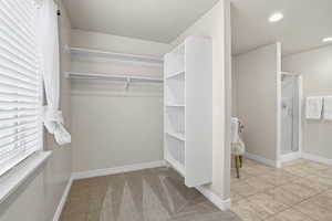 Spacious closet with light colored carpet