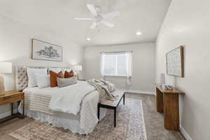 Bedroom featuring light colored carpet, ceiling fan, and recessed lighting